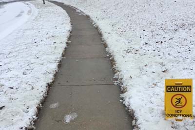 A photo of a path neatly cleared of snow and with salt anti-icing treatment